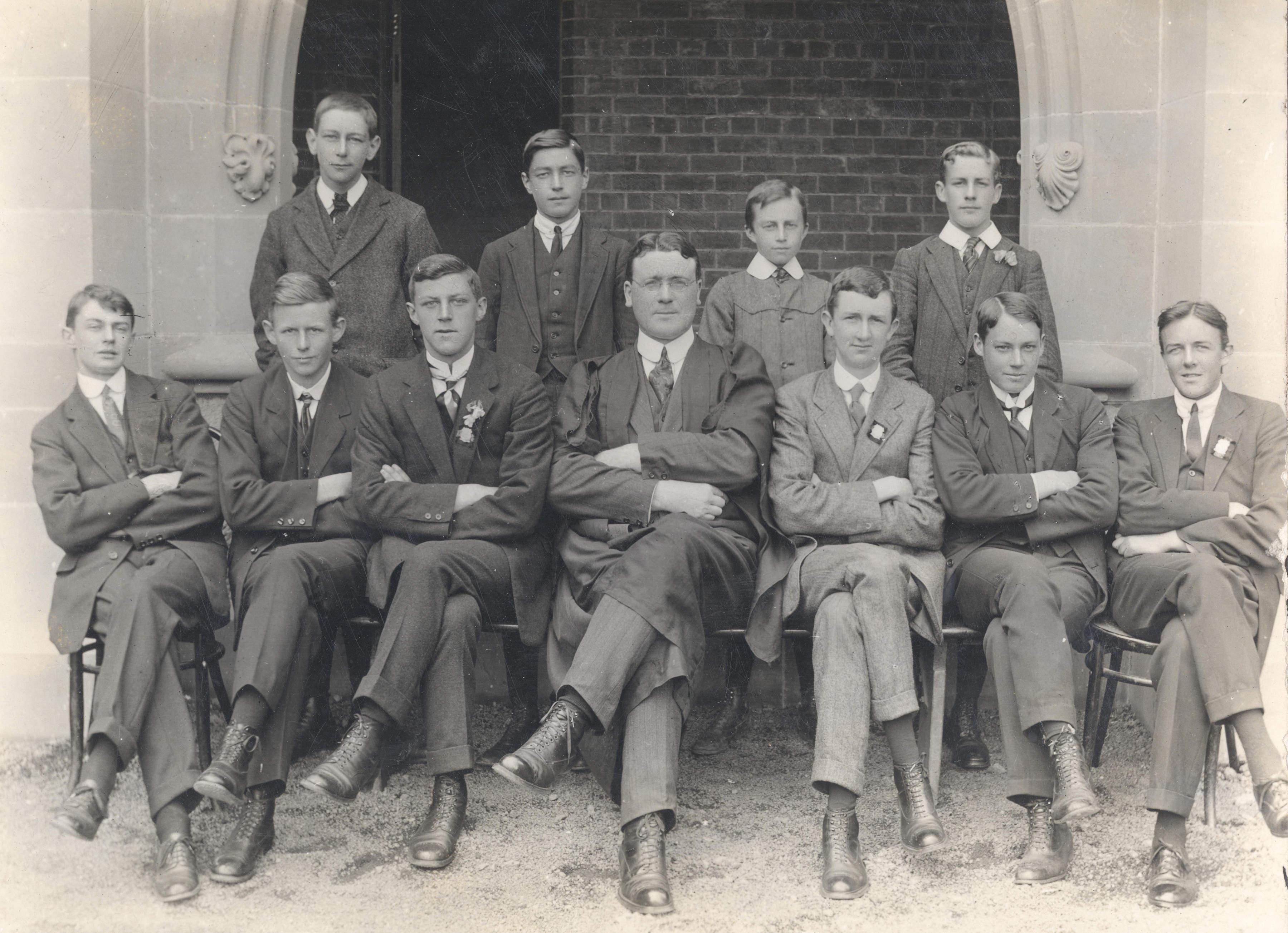 Senior Public Science class with H D Erwin, 1914. (Standing L–R) J Walch, F Richardson, D Mortyn, R Barnett. (Seated L–R) P Oldmeadow, A Clinch, M Dollery, Mr H D Erwin, J Butler, S Ross, L Payne.