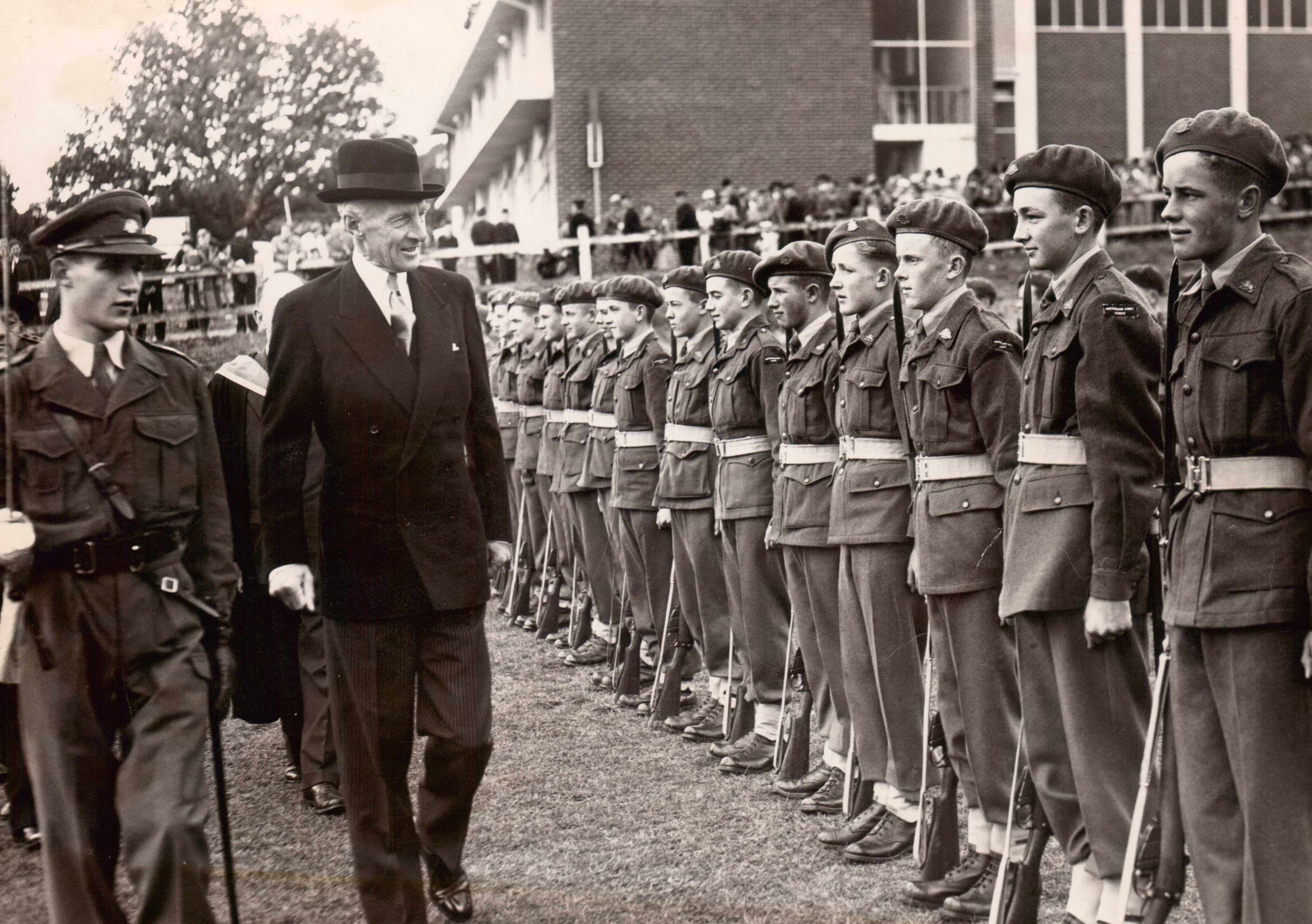 Governor Sir Ronald Cross inspecting Cadets at the opening of the Junior School, 1957.