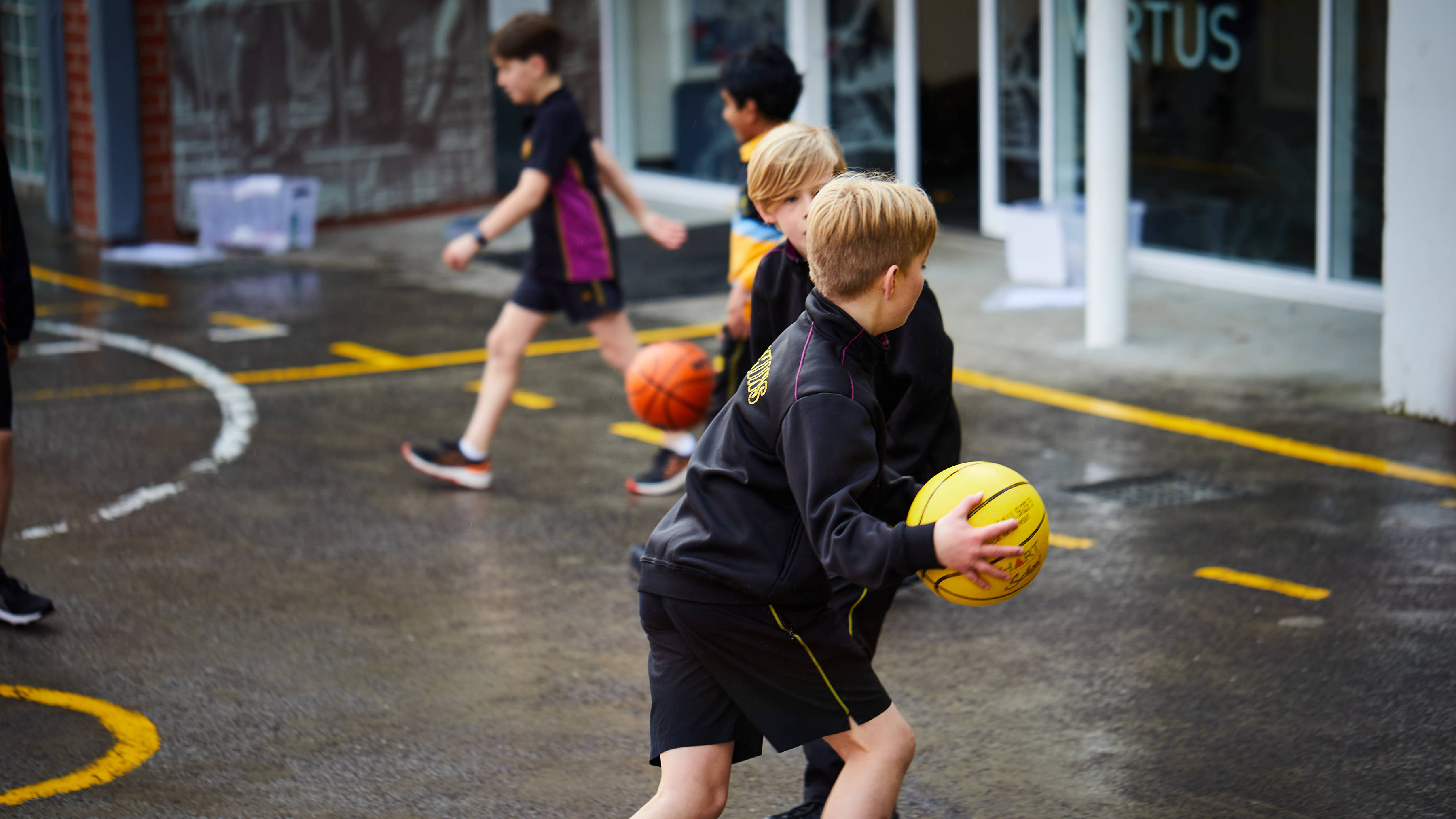 Junior School students playing basketball outdoors. Photo: Joshua Lamont.