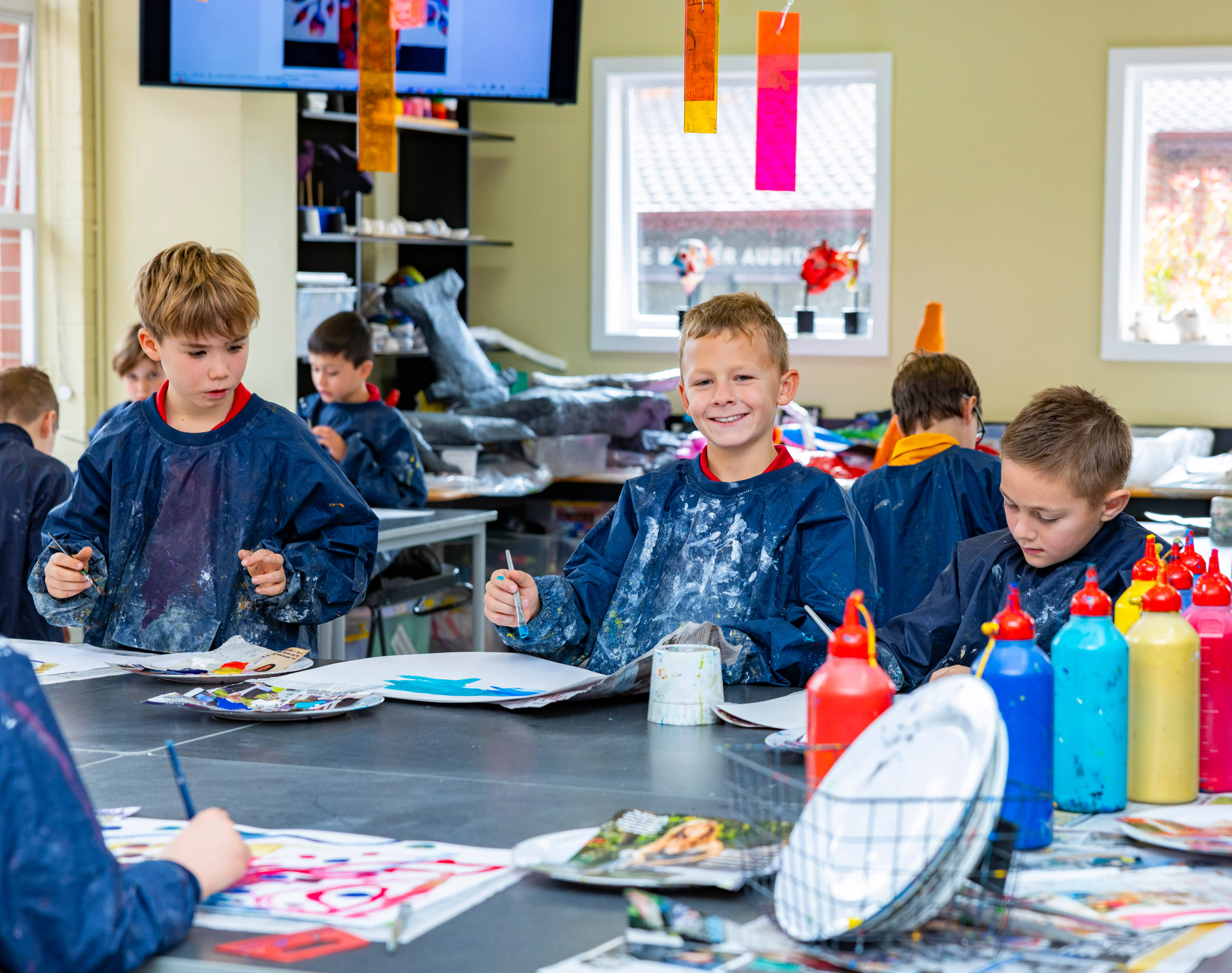 Group of Junior School students painting.