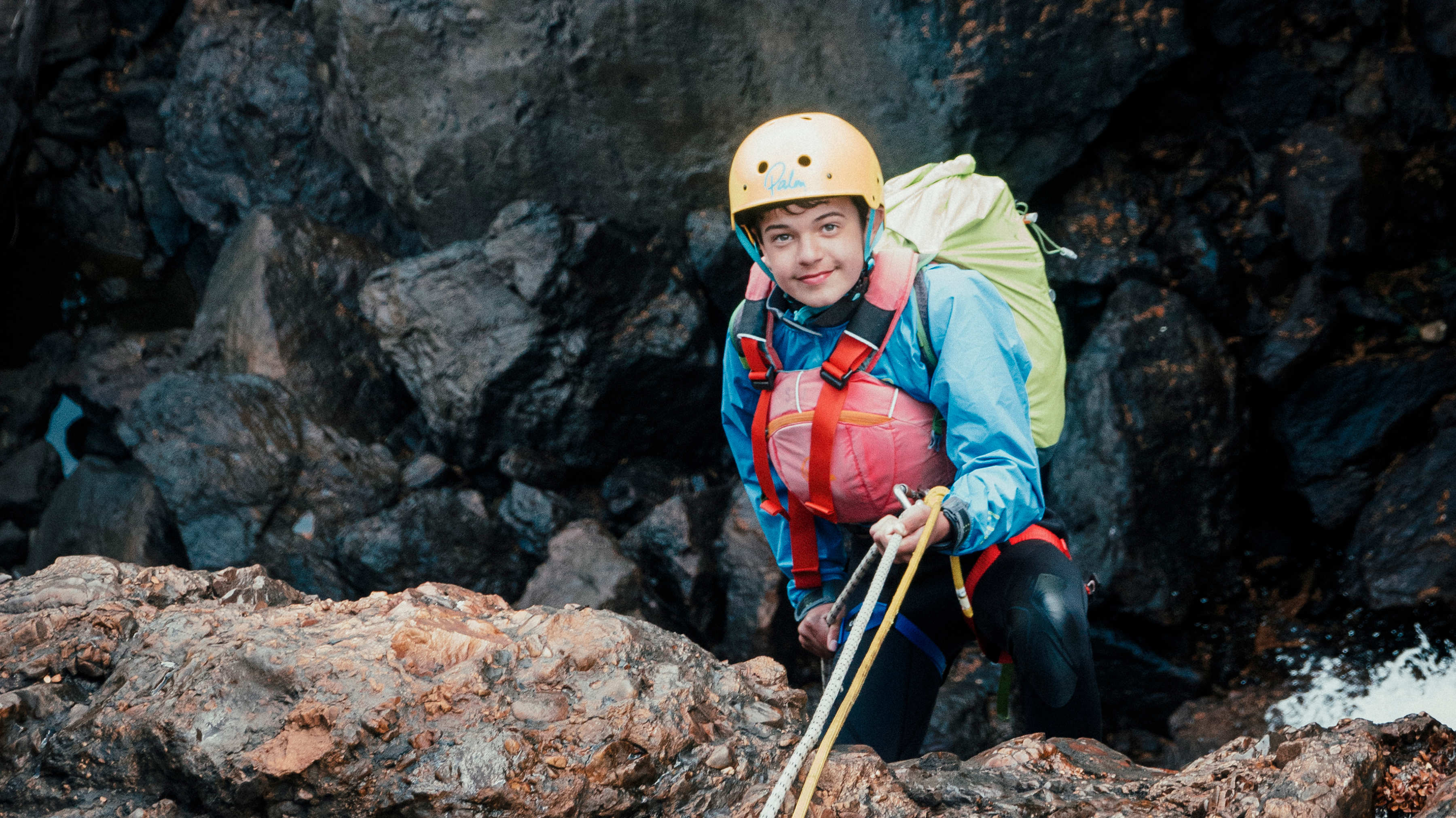 Power of 9 student rock climbing.