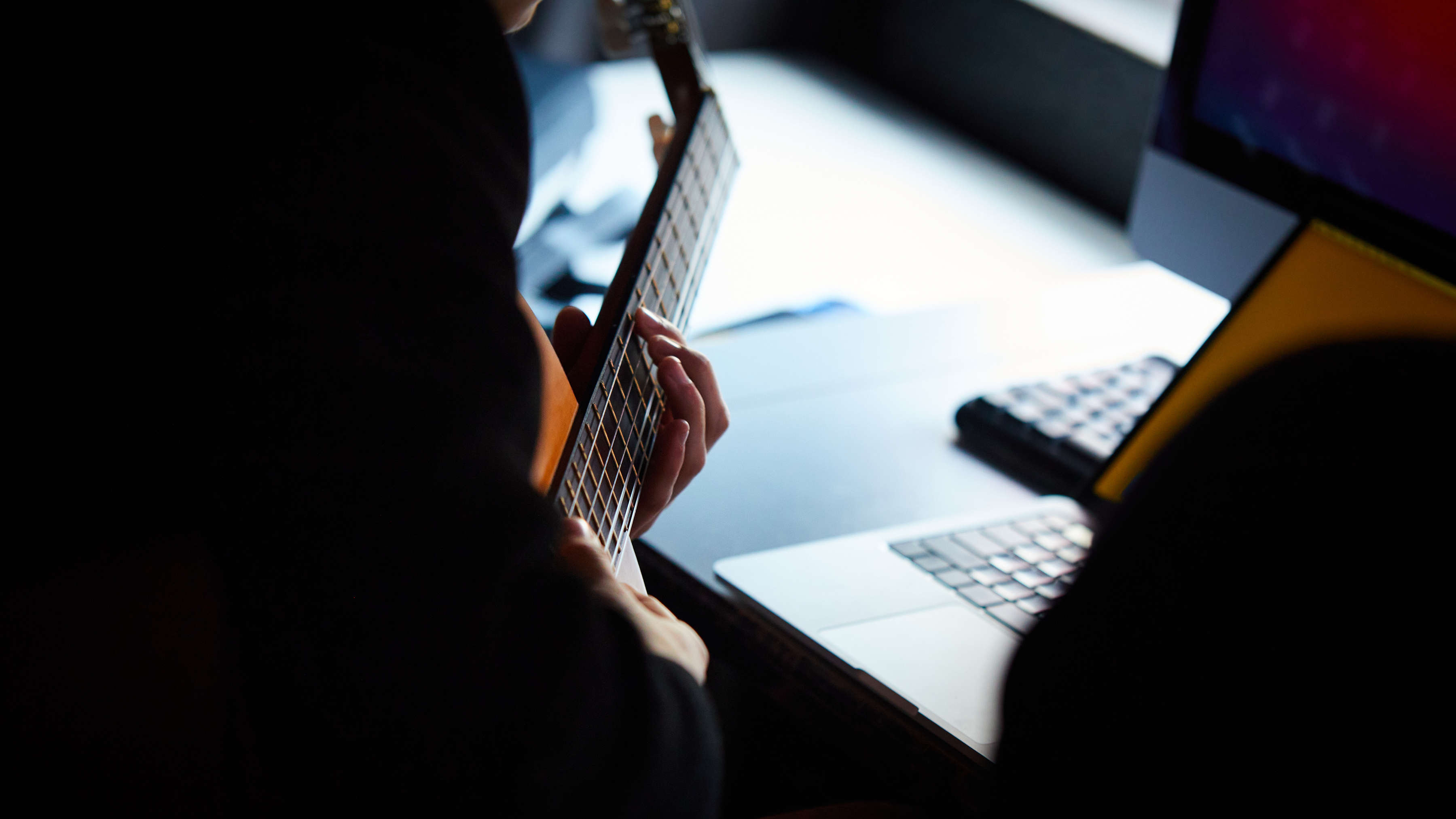 Close-up of student playing guitar. Photo: Joshua Lamont.