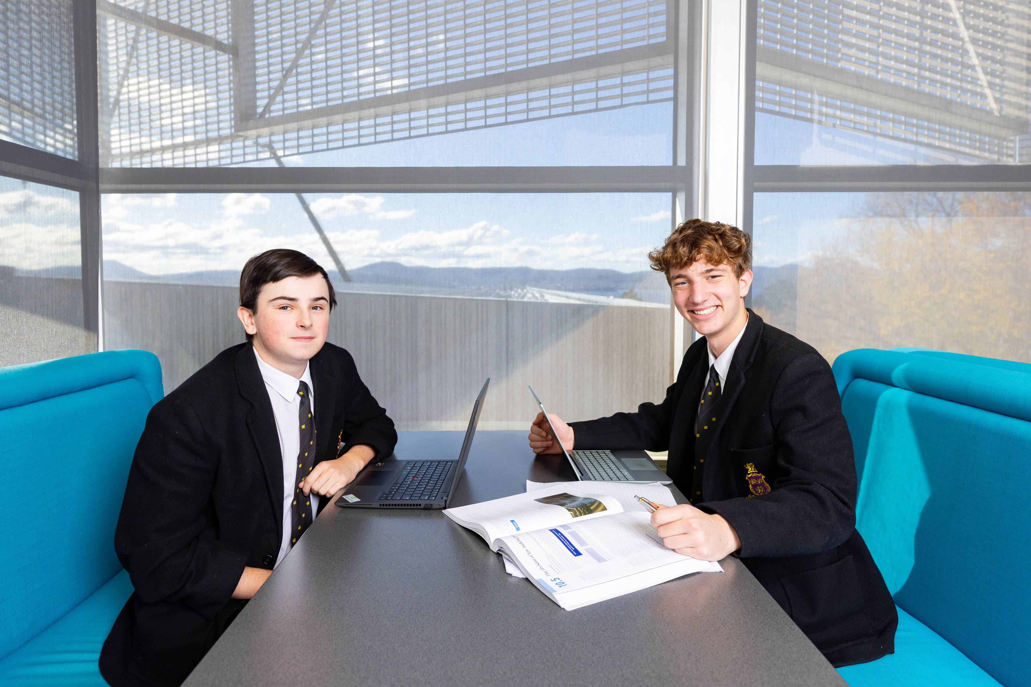 Two students working at a desk.